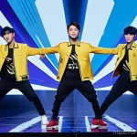 Nine Percent와 중국 아이돌 그룹의 진화 - **A C-Pop Idol Group's Fusion Performance:**
    A vibrant, dynamic full-body shot of a male C-Pop i...